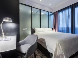 Voodi või voodid majutusasutuse Tango Inn Taipei Jihe toas