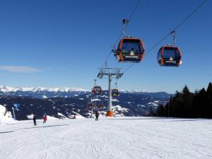 a group of people on a ski lift in the snow at Haus Peter in Murau