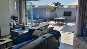 a living room with a couch and a table at Marble Blue in Cape Town