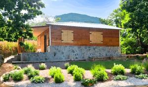 a house with a garden in front of it at Casitas Rincon Village in Santa Bárbara de Samaná