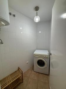 a laundry room with a washing machine and a light at La Tejita Paradise in La Tejita