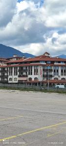 an empty parking lot in front of a large building at Gondola area, Cedar Lodge 4, apart D30, Bansko in Bansko