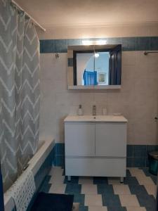 a bathroom with a sink and a tub and a mirror at Erofili Apartment in Kalyves +48 photos