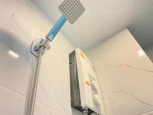 a bathroom with a shower head and a toilet at A Plus Deluxe Hotel in Ko Lipe