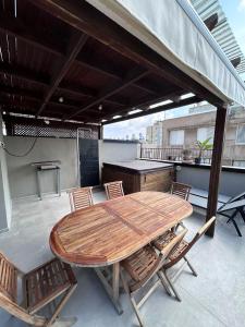 a wooden table and chairs on a rooftop patio at Luxury apartment Tel Aviv Gordon Beach Ha Yarkon in Tel Aviv