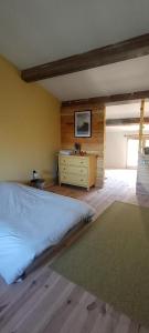 a bedroom with a bed and a dresser in it at JAS provençal pour 6 personnes à 2mn de la Grange de Javon in Monieux +5 photos