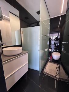 a bathroom with a sink and a glass shower at Luxury apartment Tel Aviv Gordon Beach Ha Yarkon in Tel Aviv