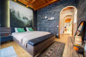 a bedroom with a large bed and a wall at FoxForest Vendégház in Zalakaros