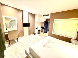 Postel nebo postele na pokoji v ubytování De Cozé Hotel
