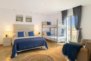 a bedroom with a bed with blue sheets and a ladder at 6 Bedroom Luxury Villa, Jacuzzi & heated pool 18 guests in Mutxamel +32 photos