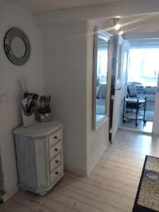 a room with a dresser and a mirror and a hallway at Daheim in Rinteln