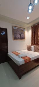 a bedroom with a large bed in a room at Layang Layang Home in El Nido