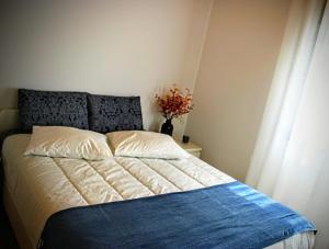 a bedroom with a bed with a blue and white blanket at Casa da Igreja-Abadim in Cabeceiras de Basto +36 photos