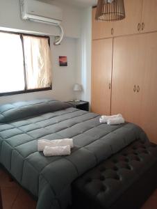 a bedroom with a large bed with two towels on it at Departamento a 150 metros de la catedral con cochera in San Fernando del Valle de Catamarca