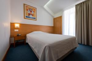 Postel nebo postele na pokoji v ubytování Hotel Matriz