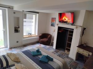 a bedroom with a bed and a fire place at Gîte Quai N 10 in Saint-Valery-en-Caux