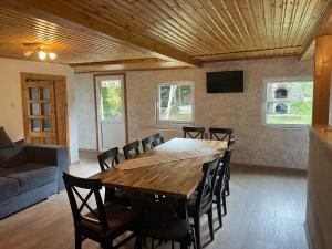 a dining room with a wooden table and chairs at Casa Mărioara in Şirnea