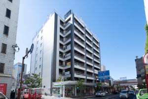a tall building on a busy city street at Richmond Hotel Kagoshima Tenmonkan in Kagoshima