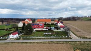 an aerial view of a farm with houses and a road at Domek w górach in Nadziejow