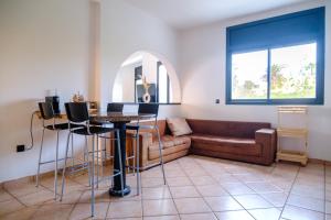 a living room with a couch and a table at Sunset escape by the sea in Temara