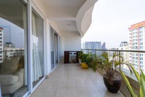 a balcony of a building with plants on it at Elegant 2 BED apt in Kilimani with balcony views in Nairobi