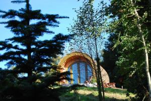 a building on top of a hill with trees at Ty Barcud Glamping Pod in Aberystwyth