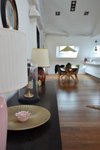 a living room with a table with a plate on it at Grand loft 110m Cœur historique Angers et parking privé Rare in Angers