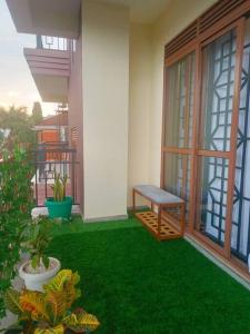 a balcony with a bench on the side of a house at Serene Homes 01 in Kampala