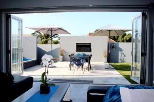 a living room with a view of a patio at Marble Blue in Cape Town