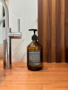 a bottle of liquid soap sitting on a counter next to a sink at Luxuriöses Apartment im historischen Wangen in Wangen im Allgäu