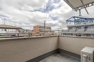 a balcony with a brick wall and a fence at MiShe主题南行徳民宿 in Tokyo