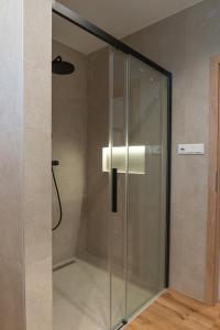 a shower with a glass door in a bathroom at Villa Studenec in Banská Štiavnica