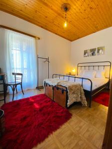 a bedroom with a bed and a red rug at Forrest Guesthouse in Polídhroson