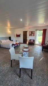 a living room with a bed and a living room with white furniture at Posada Los Molles in Colón +55 photos