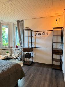 a bedroom with a bed and shelves in a room at Cozy Oldhouse Appartment Varenseller in Rheda-Wiedenbrück