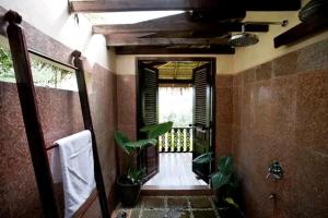 a bathroom with a walk in shower next to a porch at Zen Namkhan Boutique Resort in Ban Xianglôm