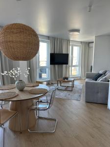 a living room with a table and a couch at Апартаменти Мон Блан in Khmelʼnytsʼkyy +41 photos