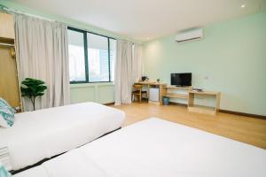Postel nebo postele na pokoji v ubytování Kingston Hotel 8 - Kuala Lumpur Bukit Bintang