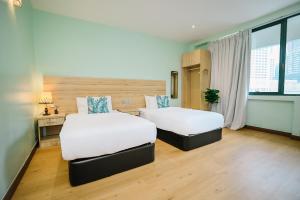 Postel nebo postele na pokoji v ubytování Kingston Hotel 8 - Kuala Lumpur Bukit Bintang