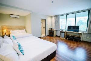 Postel nebo postele na pokoji v ubytování Kingston Hotel 8 - Kuala Lumpur Bukit Bintang