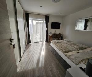 a hotel room with a bed and a large window at Sunny room 1 in Dinkelsbühl