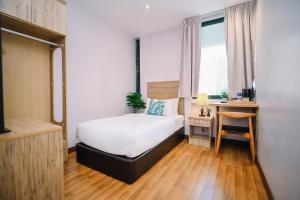Postel nebo postele na pokoji v ubytování Kingston Hotel 8 - Kuala Lumpur Bukit Bintang