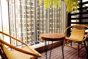 a table and chairs on a balcony with a window at Chillab Homestay in Gia Lâm Pho