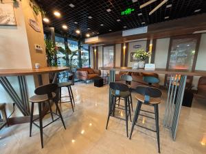 una barra en un restaurante con taburetes en Apartments 1 line sea WYN RESIDENS, en Batumi