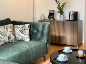a living room with a green couch and a table at Apartment in Grimma mit 2 Schlafzimmer in Grimma