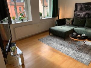 a living room with a couch and a table at Apartment in Grimma mit 2 Schlafzimmer in Grimma