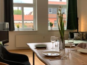 a dining room table with glasses and a vase on it at Apartment in Grimma mit 2 Schlafzimmer in Grimma +3 photos