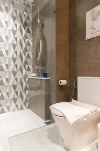 a bathroom with a toilet and a shower at Title Halo I Sea You Naiyang Pool Gym Sauna in Nai Yang Beach