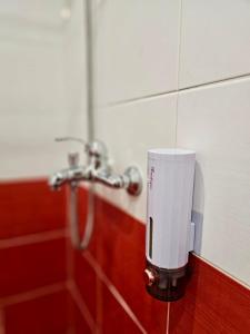 a soap dispenser in a bathroom with a shower at Tirana Apartment in Kashari