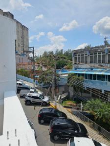 a parking lot with cars parked in front of a building at Apartamento 02 Aparecida do norte 2 andar in Aparecida